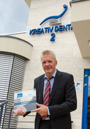 Attila Knott mit der Auszeichnung für die Kreativ Dental Klinik